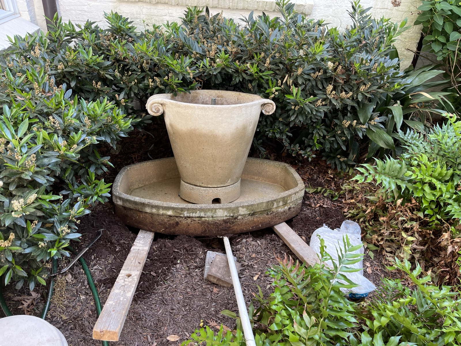 Fountain being lifted with wood blocks during releveling, Raleigh NC