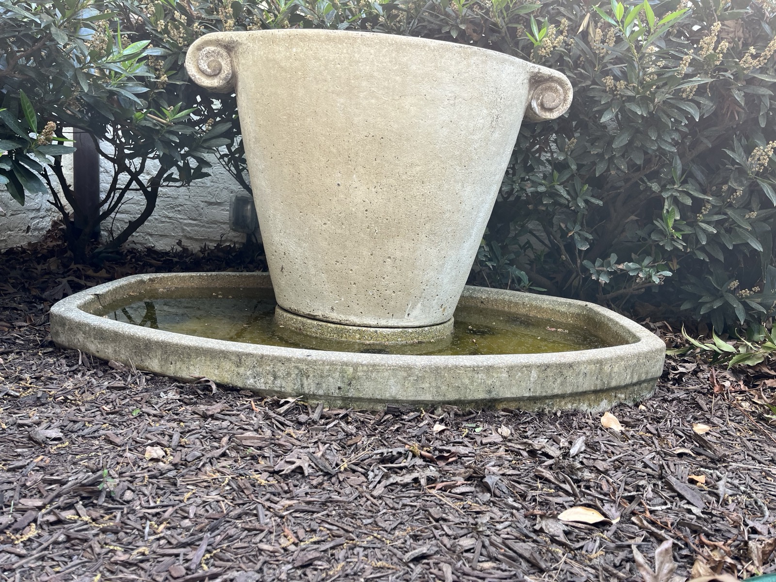 Urn fountain sunken into mulch before releveling, Raleigh NC